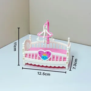 Miniature dollhouse baby crib pink cradle toy with mobile and cute heart cat decoration.