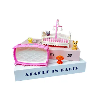 Miniature dollhouse baby crib toy with cute little animal figures, pink and white cradle decor.