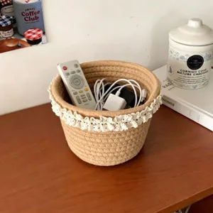 Detail view of the woven storage basket with lace trim, perfect for desktop organization and decor.