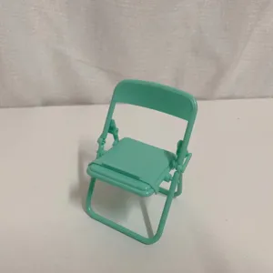 Mini folding chair phone stand detail view, cute macaron green desktop decoration ornament.