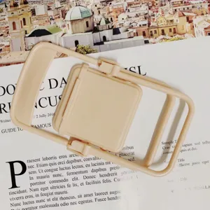 Detail shot of mini foldable chair phone stand, cute desktop stand for smartphone and earphones.