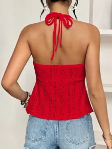 Back detail view of red halter eyelet crop top showcasing stylish tie back design.