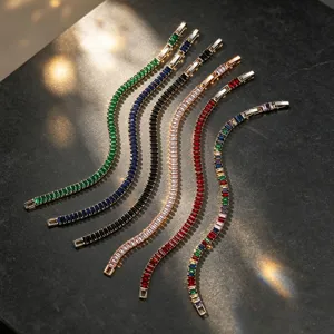 Detailed view of AAA zircon bracelets in multiple colors on a textured dark background
