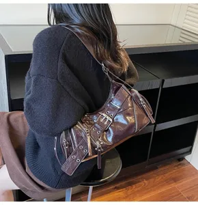 Dark brown glossy biker shoulder bag with stylish metal buckles and zipper details.