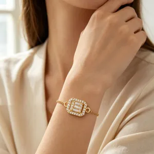 Elegante bracciale a catena dorata con zircone rettangolare indossato da una modella