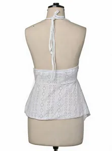 Back view close-up of white halter top, featuring delicate eyelet embroidery and tie straps.