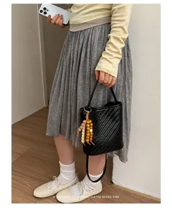 Minimalist black woven soft leather bucket bag with bead charm for elegant daily commuting