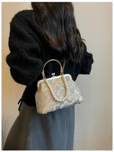 Elegant embroidered floral evening clutch bag with pearl handle and metal clasp