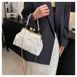 Close-up of white 3D floral lace evening bag featuring a faux pearl handle and gold chain strap