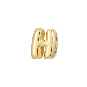Detailed macro view of a 3D gold bubble letter H charm for DIY necklace accessories
