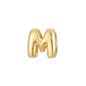 Detailed view of a polished gold bubble letter M charm for custom DIY jewelry making