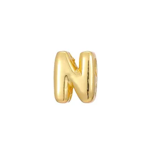 Macro detail of a 3D gold bubble letter N pendant for custom DIY jewelry making