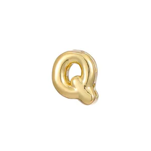 Detailed close-up of a polished gold bubble initial letter Q pendant for DIY jewelry