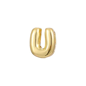 Close-up of a polished gold bubble letter U charm featuring a smooth and shiny metallic finish