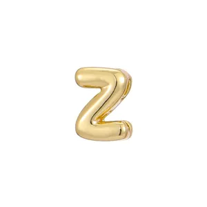 Macro view of a shiny gold bubble letter Z charm accessory for DIY jewelry pieces.