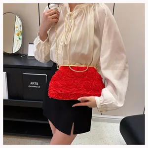 Detail view of red 3D rose evening bag featuring rhinestone clasp and gold chain