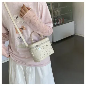 Korean style cream white studded box handbag being worn as a stylish crossbody phone bag