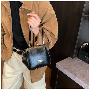 Sac à main vintage en cuir souple noir avec fermoir à clip dans un style automnal