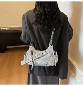 Back view of model wearing a light blue motorcycle underarm bag with belt details.