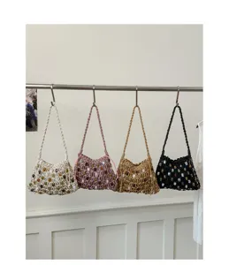 Bohemian woven mesh shoulder bags with colorful beads in four colors hanging on a rack