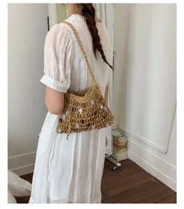 Casual woven beaded shoulder bag with drawstring detail shown on model side profile