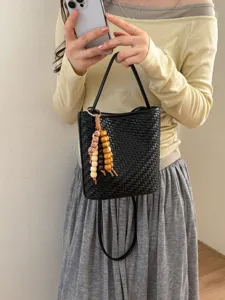 Korean style black woven soft leather bucket bag with wooden bead tassel charm.