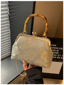Floral embroidered evening clutch bag featuring a unique bamboo handle and gold chain
