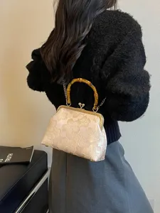 Elegant floral embroidered shell evening bag with bamboo handle and gold chain strap