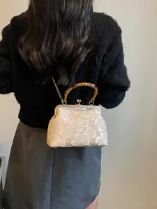 Elegant vintage-style embroidered flower evening shell bag with a unique bamboo handle