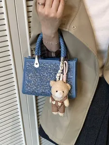 Stylish summer denim blue woven tote bag with sequin details and a cute plush bear charm