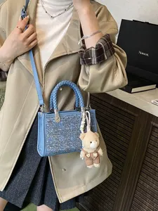 Fashionable blue denim tote bag with woven handles and sparkly sequins