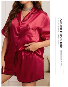 Close-up of elegant burgundy satin pajama set featuring delicate black piping detail