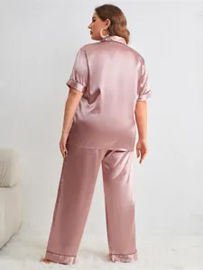 Back view detail of plus size satin pajama set in dusty pink with black piping