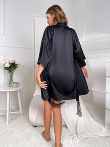 Back view of an elegant black silk satin loungewear robe with delicate tassel trim detail