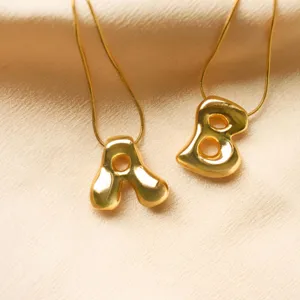 Close-up of 18K gold plated bubble letter A and B balloon style pendant necklaces