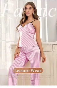 Elegant detail view of women's pink striped satin pajama set featuring cami top and long pants