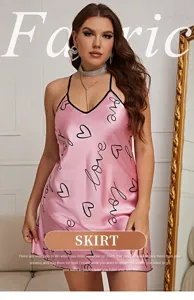 Close-up of elegant pink satin slip dress featuring romantic heart and love patterns