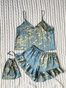 Blue silk-like pajama set with botanical print, camisole and ruffled shorts detail