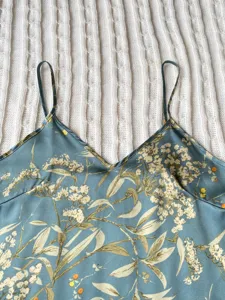 Detailed view of elegant blue floral satin camisole pajama top with V-neckline