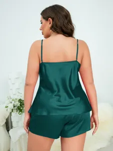 Back view of a women's dark green satin camisole and shorts pajama set.