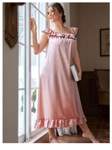 A lifestyle detail of a plus size pink satin nightgown with elegant lace trim details