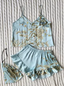 Detailed view of blue floral print satin pajama set with camisole and ruffled shorts