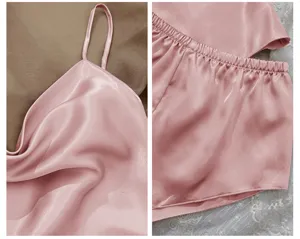 Detailed close-up of pink satin pajama set showing silk fabric texture and elastic waistband