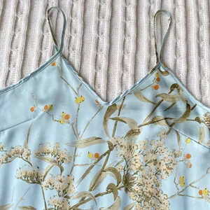 Close-up of light blue floral satin camisole with delicate V-neck and thin straps