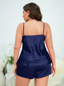 Detailed back view of a women's plus size navy blue satin pajama camisole and shorts set