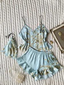 Detail view of light blue floral faux silk pajama set with matching drawstring pouch