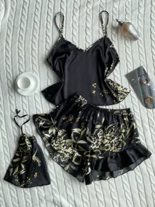 Detailed view of black floral print satin pajama set with camisole and ruffle shorts