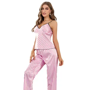Pink and white striped satin pajama set featuring a camisole top and long pants