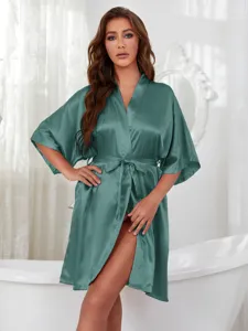 Elegant sage green satin robe with tie waist shown in a luxury bathroom setting