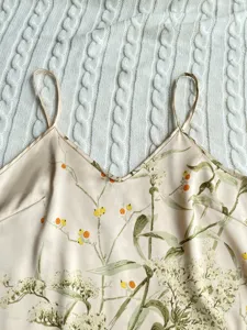 Close-up of floral print faux silk camisole with delicate straps and V-neckline